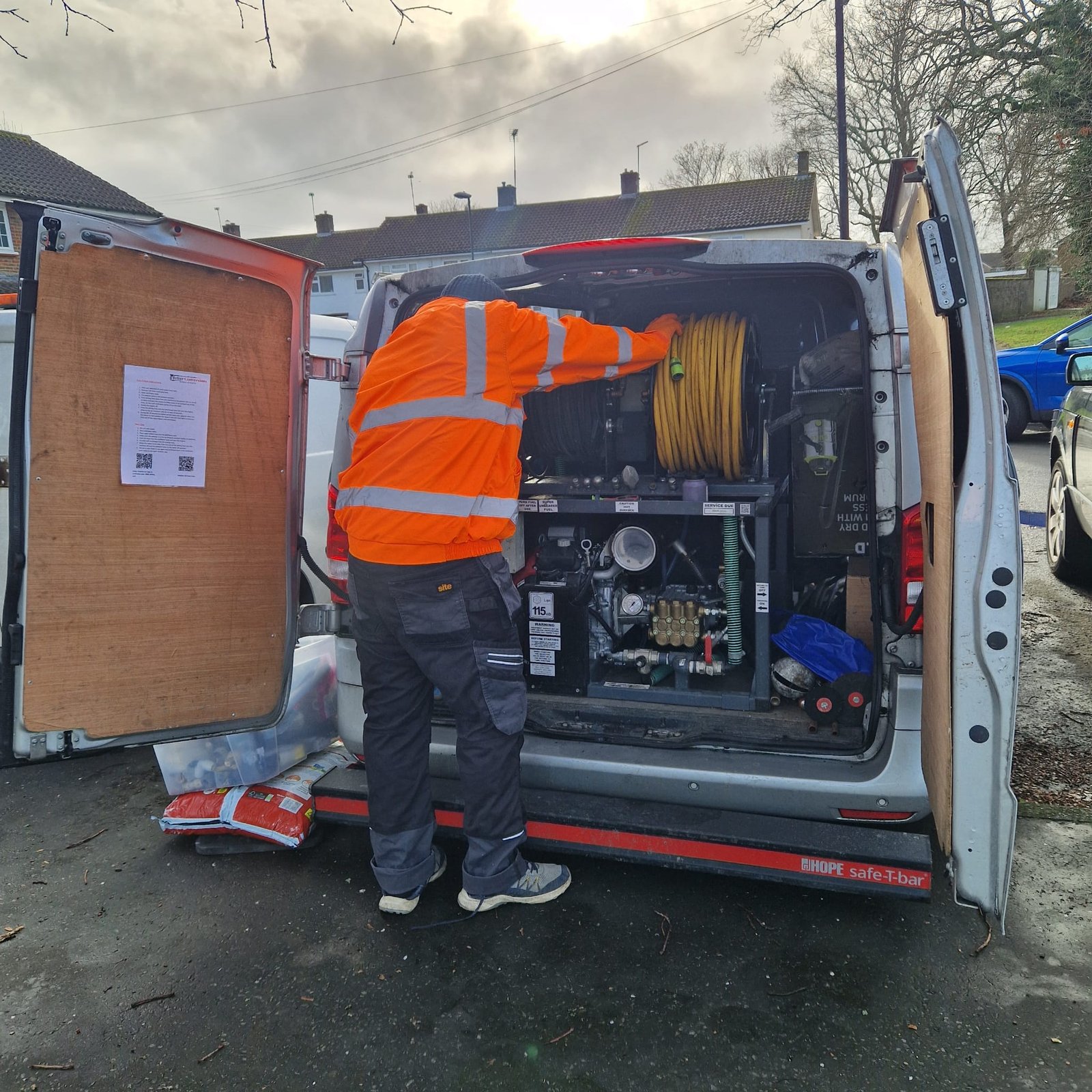 Local drain cleaning engineer operating high-pressure jetting equipment