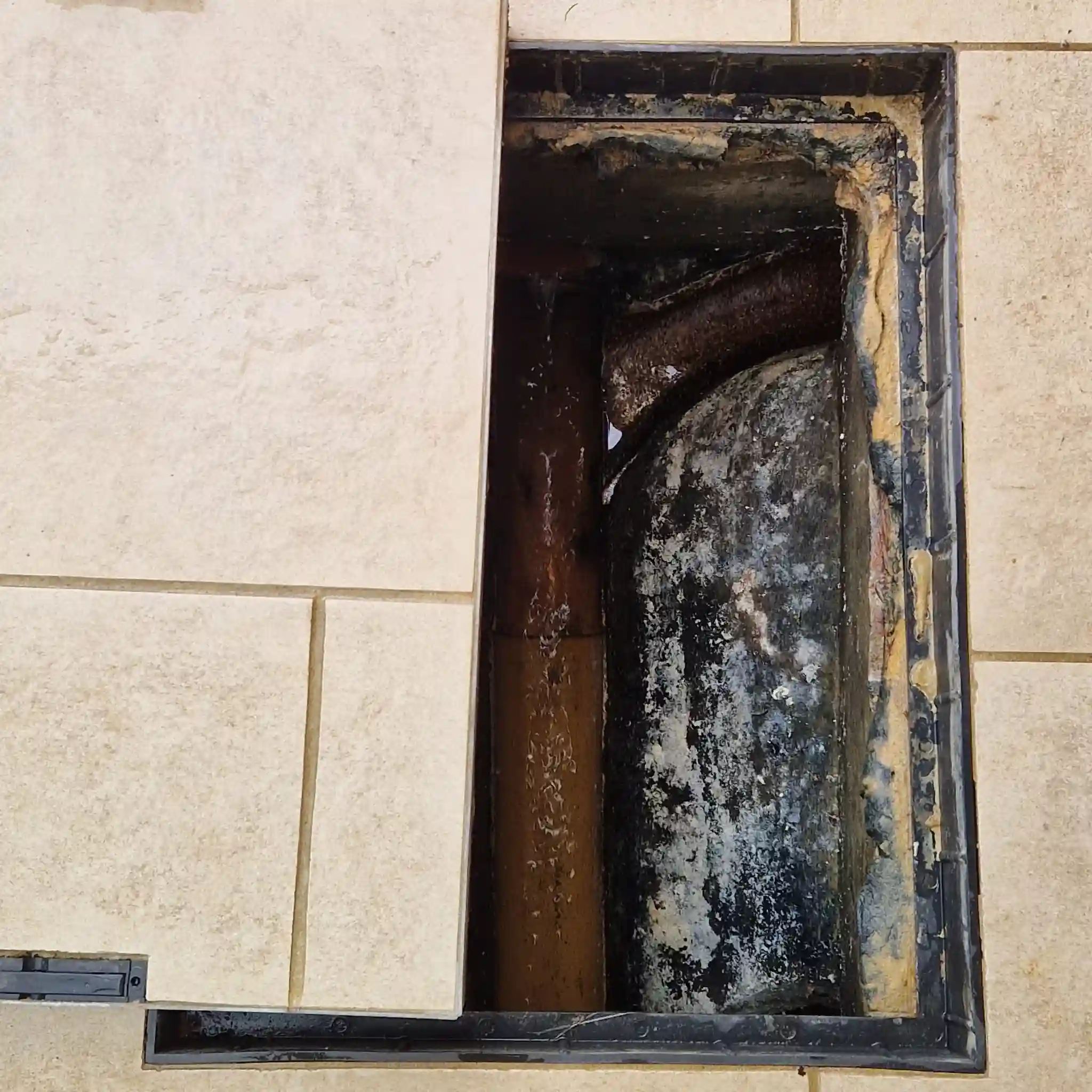 ngineer performing external drain maintenance Brighton to clear a severe blockage.