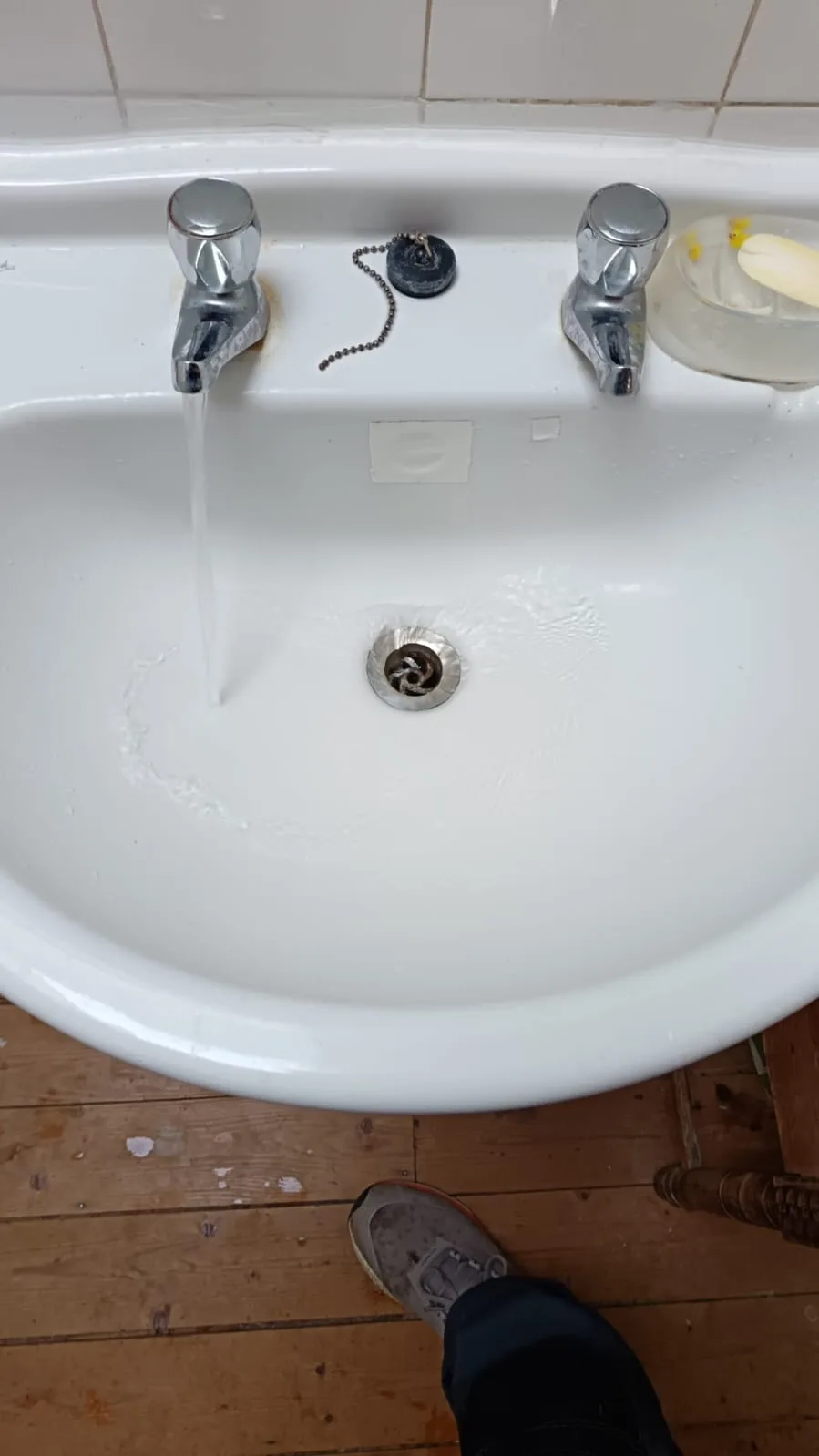 Checking water flow after learning how to unblock a toilet without a plunger