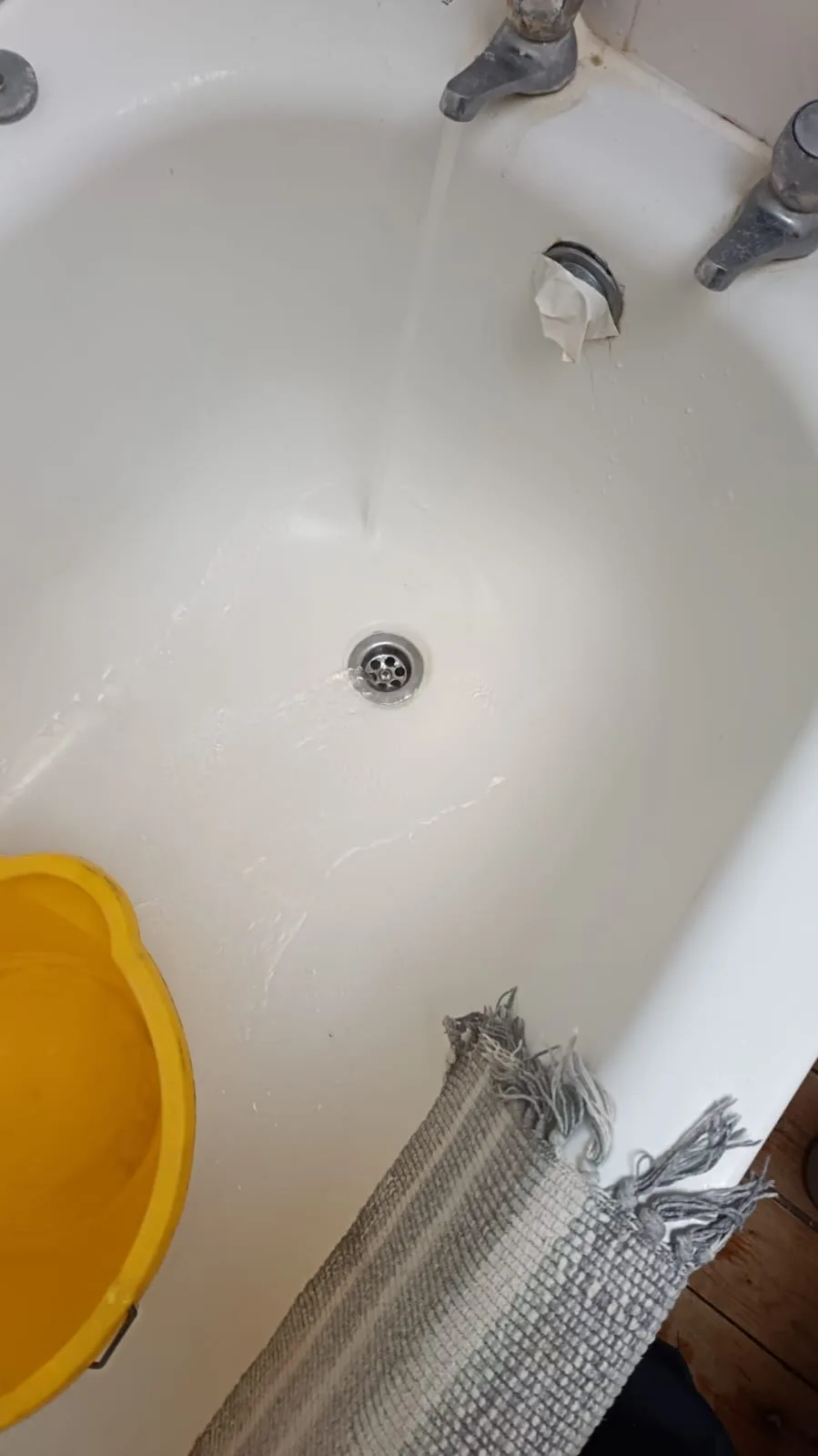 Bath tap running to prove waste drains freely after clearance