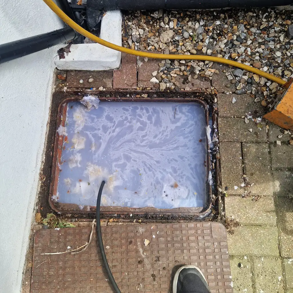 Waste water backed up in an inspection chamber awaiting high pressure jetting in Worthing