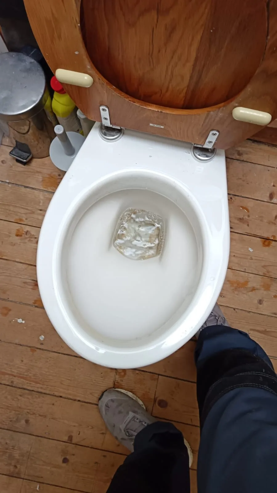 Removing a clump of hair from a bath plughole with a drain claw