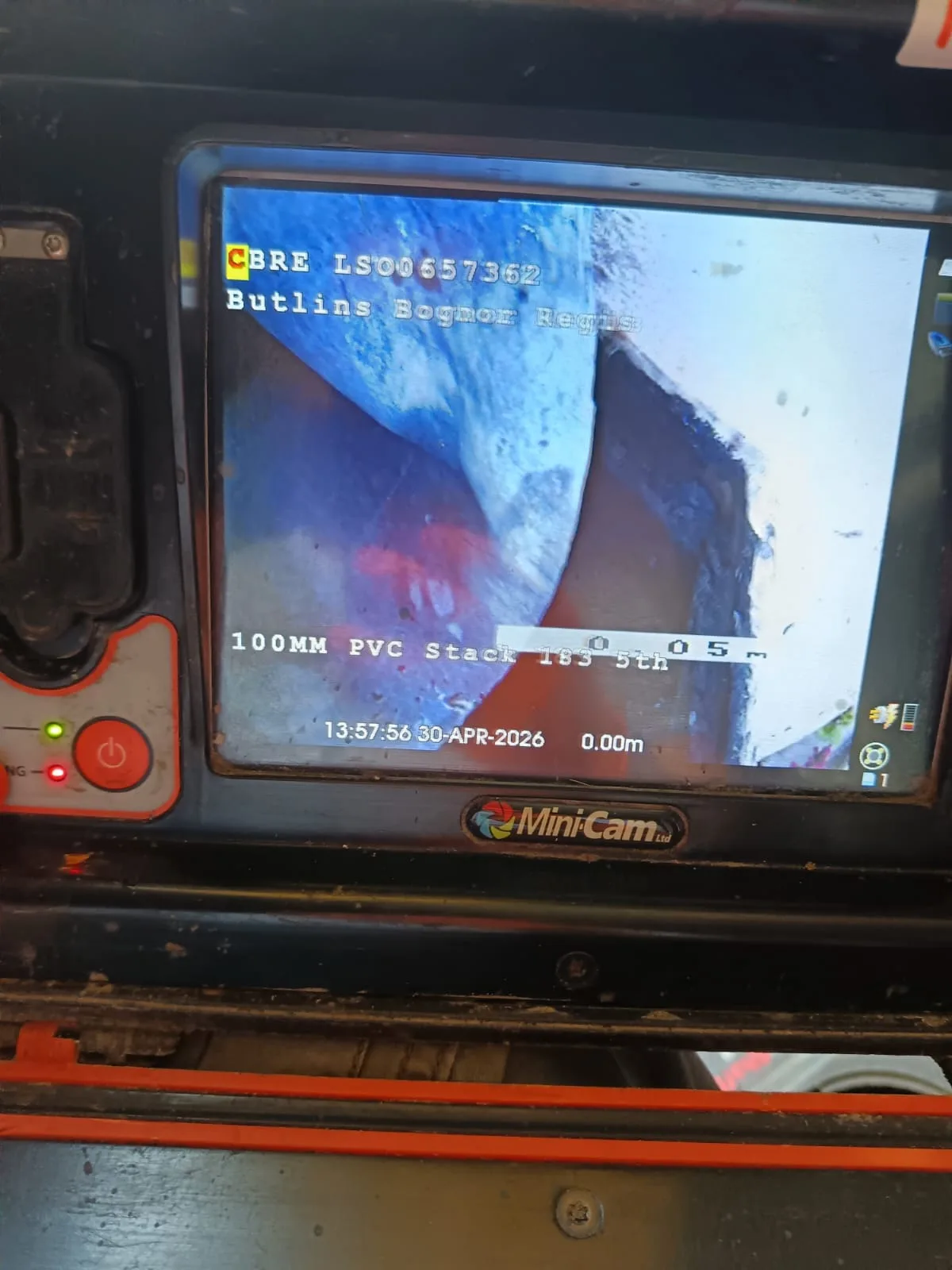 CCTV drain survey camera being fed into a blocked drain
