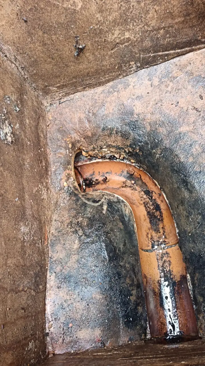 Clay interceptor pipe inside deep brick manhole chamber before cleaning on a Bromley drainage call-out