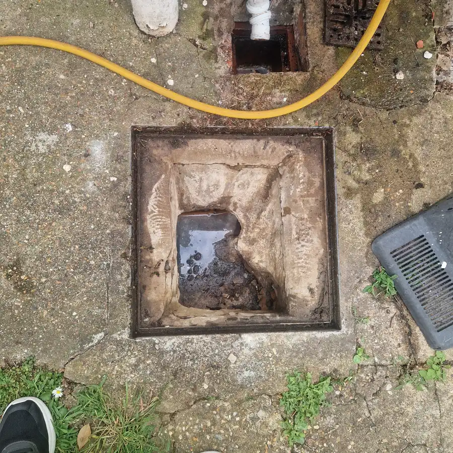 Inspection chamber almost clear of waste following high pressure jetting in Hornchurch
