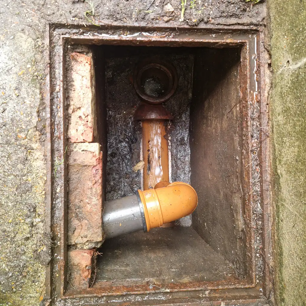 New plastic bend fitted inside chamber during drain repair works in Battersea