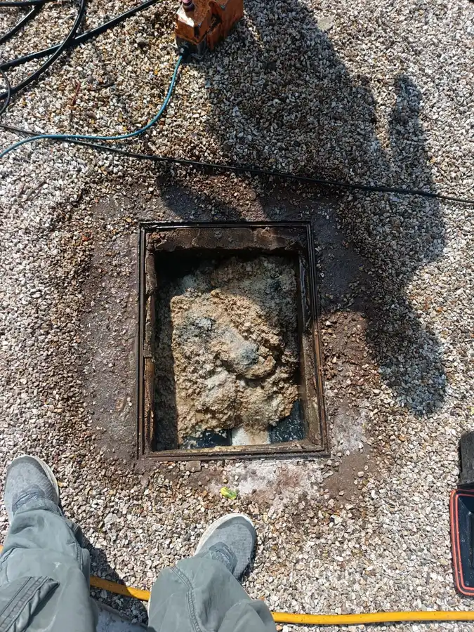 Inspection chamber blocked solid with compacted fat before jetting in Worthing