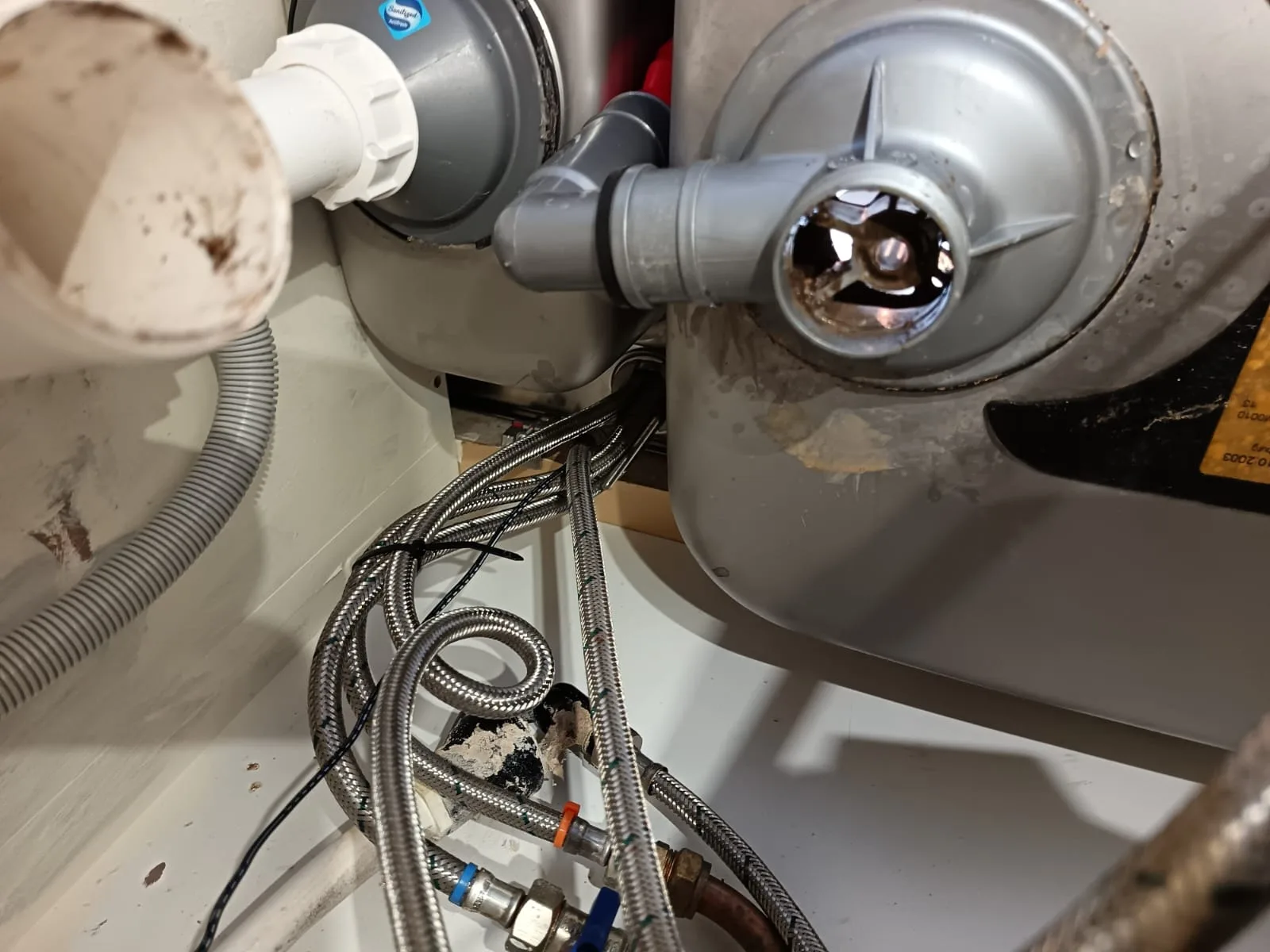 Dismantled kitchen sink waste trap during DIY drain unblocking - how to unblock a drain