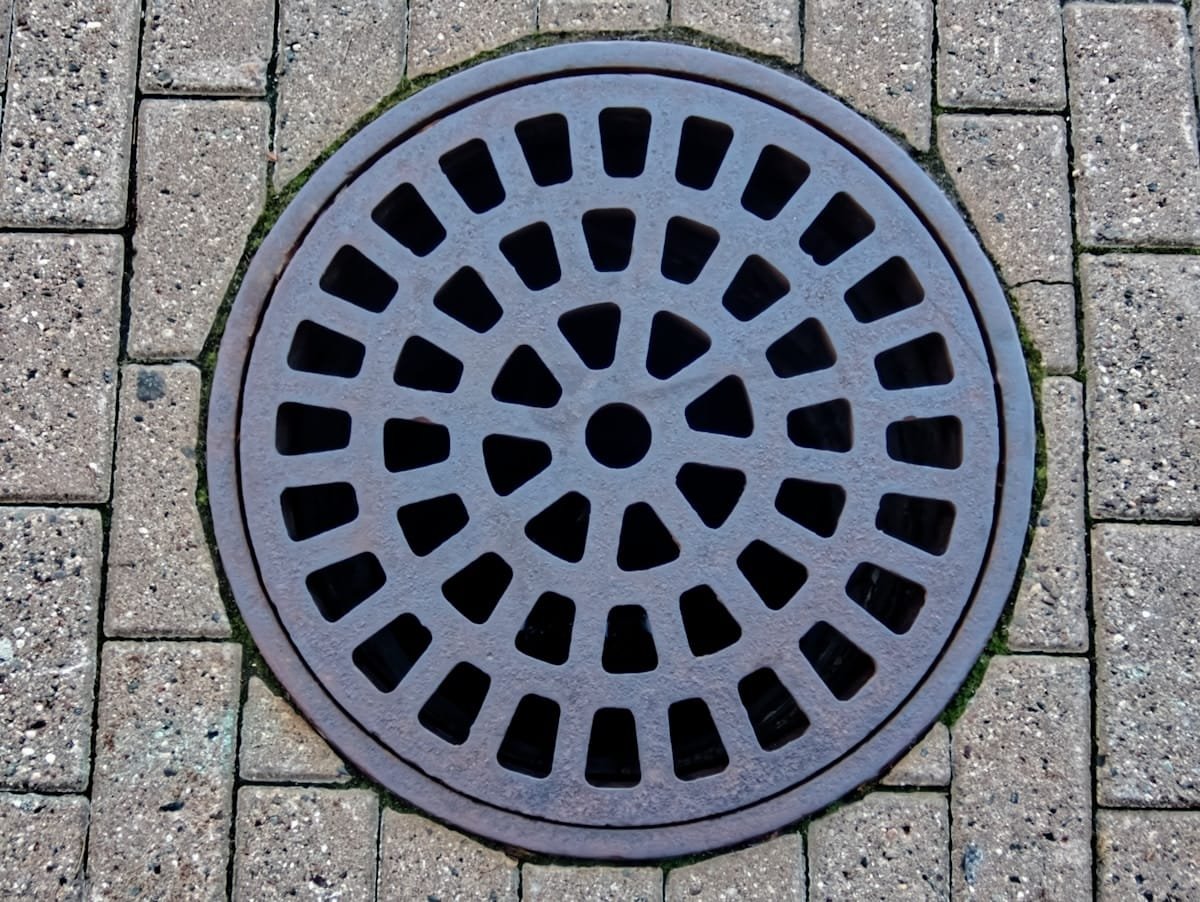 Manhole cover over a drain inspection chamber, used to check for a blocked drain