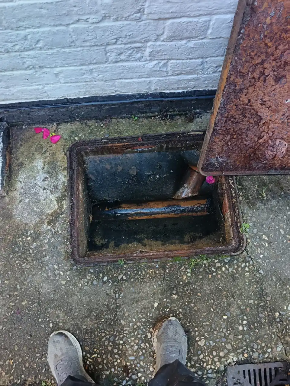 Open manhole cover during drain excavation cost assessment
