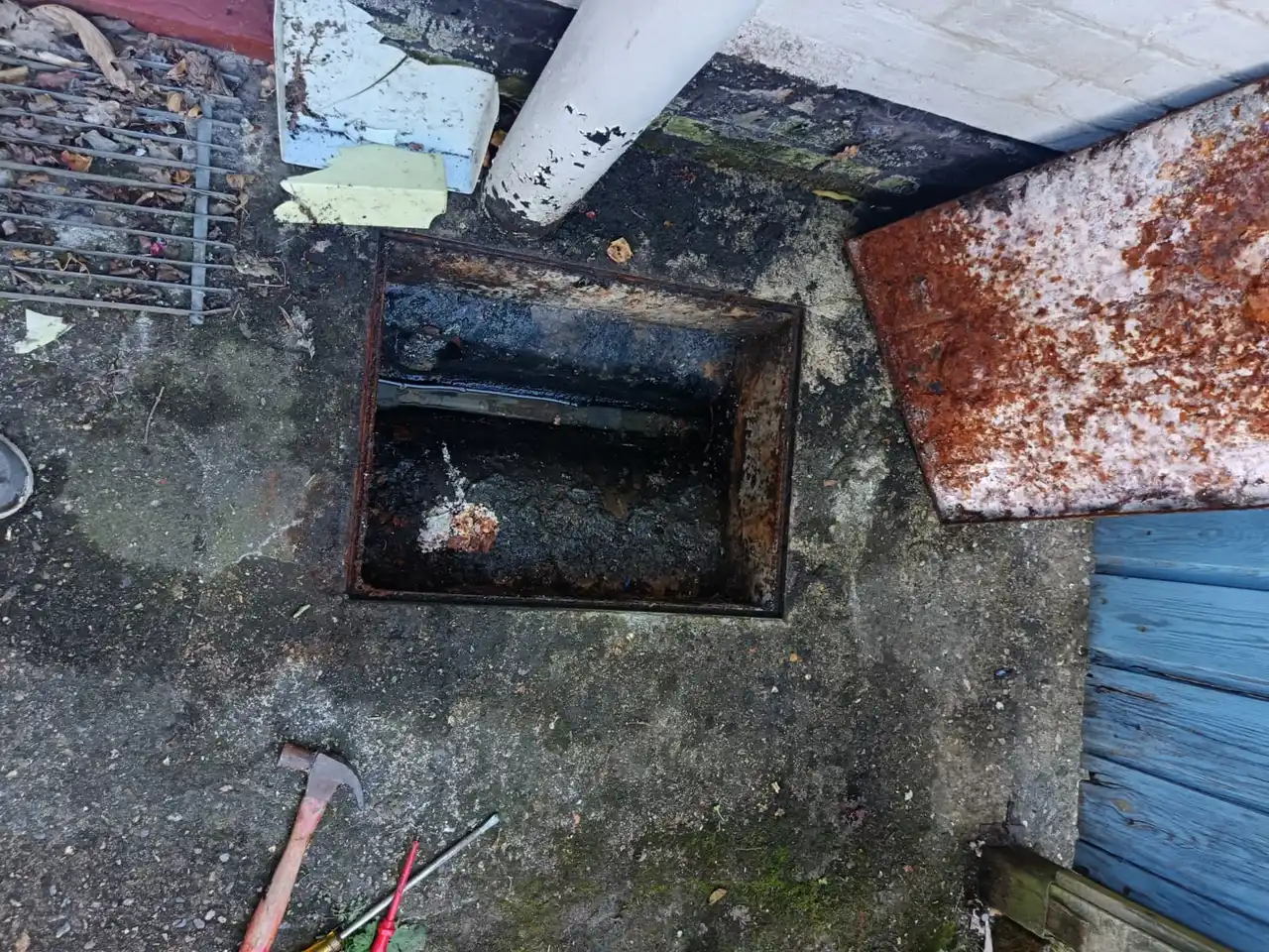 Opened drain chamber heavily silted with black waste deposits found during Hornchurch drain survey
