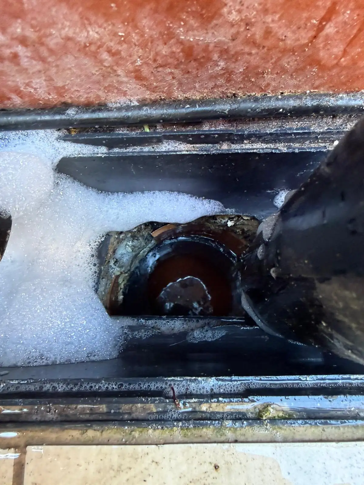 Water flowing freely through a gully after drain repair work